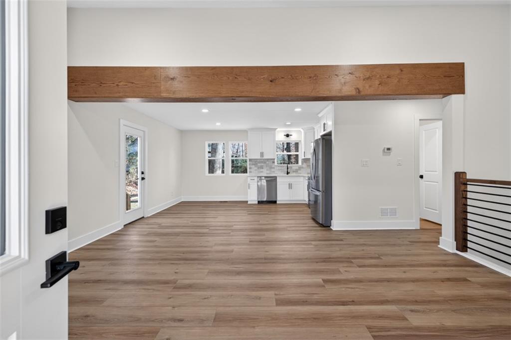 4190 Heather Way Cumming, GA 30041 - Photo 7 of 45 a view of a kitchen with wooden floor and a refrigerator