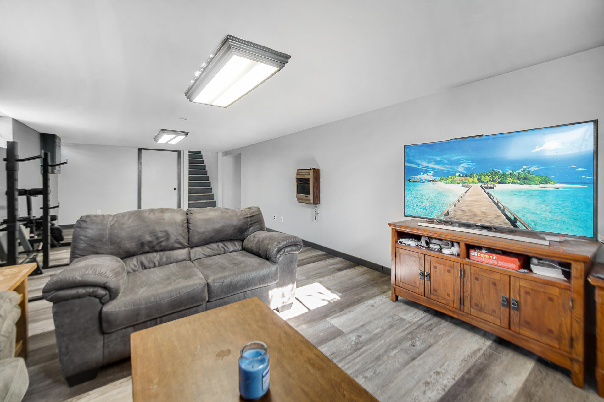 612 Almond Street Northwest De Motte, IN 46310 - Photo 19 of 27 a living room with furniture and a flat screen tv