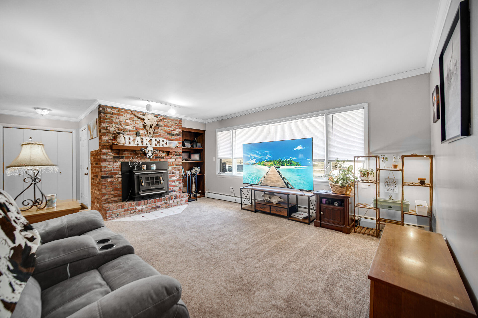 612 Almond Street Northwest De Motte, IN 46310 - Photo 2 of 27 a living room with furniture and a flat screen tv