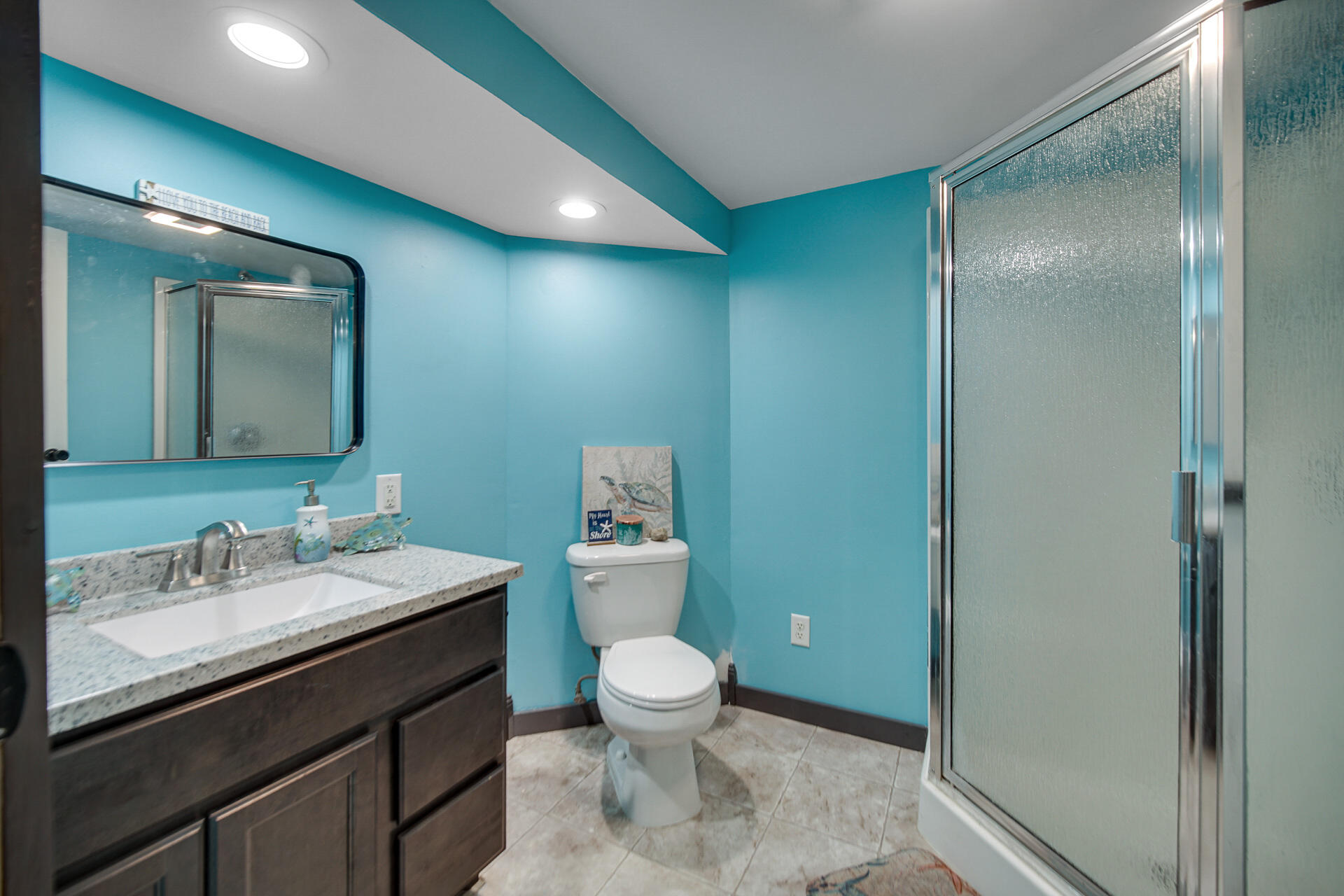 612 Almond Street Northwest De Motte, IN 46310 - Photo 21 of 27 a bathroom with a sink a toilet a mirror and vanity