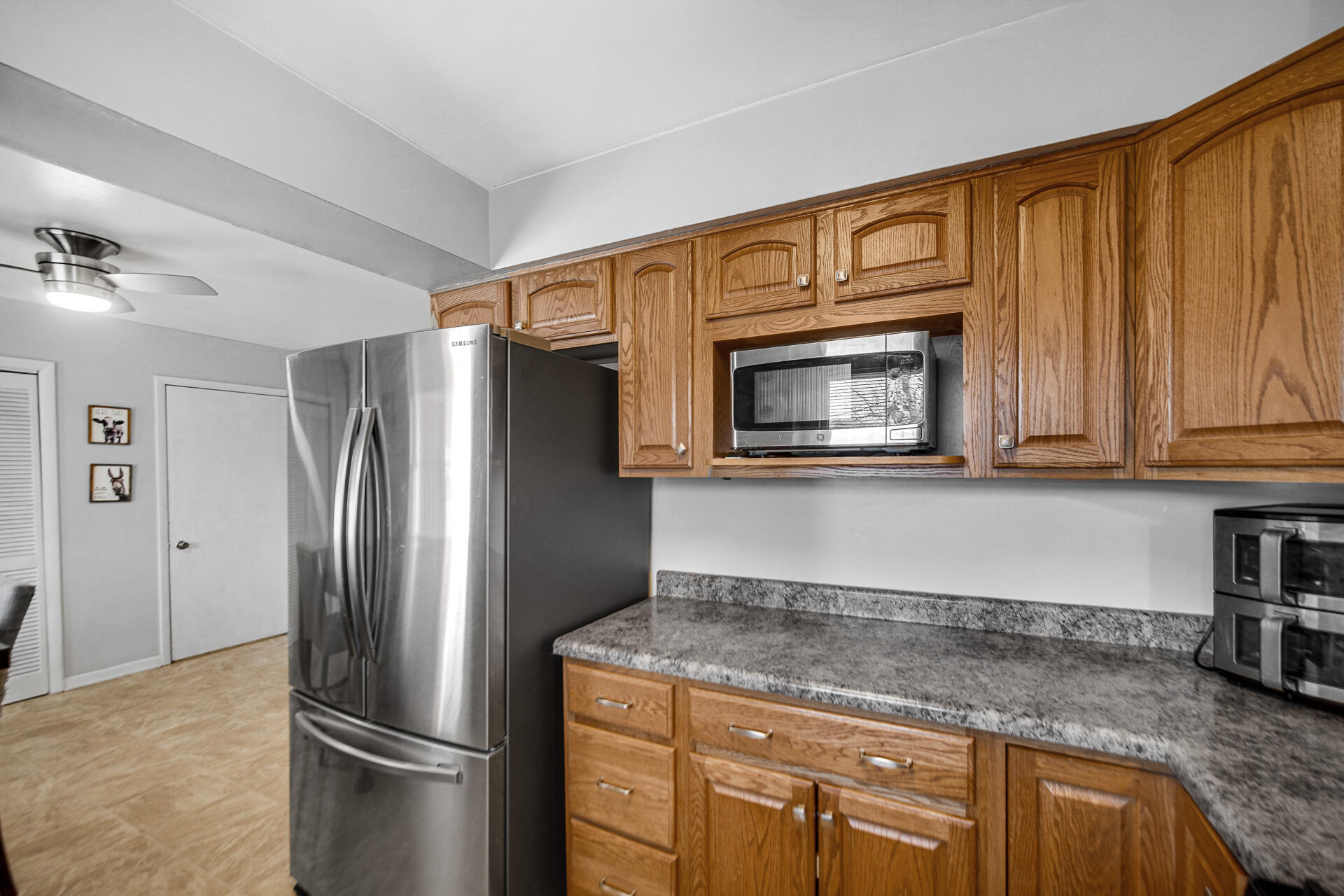 612 Almond Street Northwest De Motte, IN 46310 - Photo 9 of 27 a kitchen with granite countertop stainless steel appliances and a counter top space