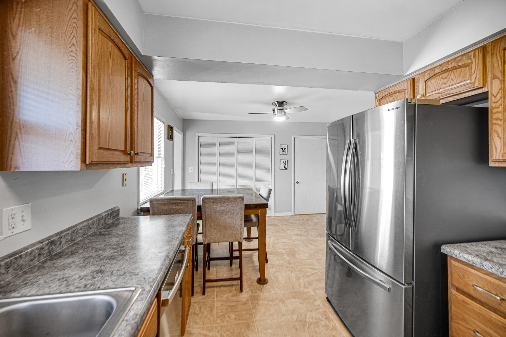 612 Almond Street Northwest De Motte, IN 46310 - Photo 10 of 27 a kitchen with stainless steel appliances granite countertop a refrigerator a sink a stove and island