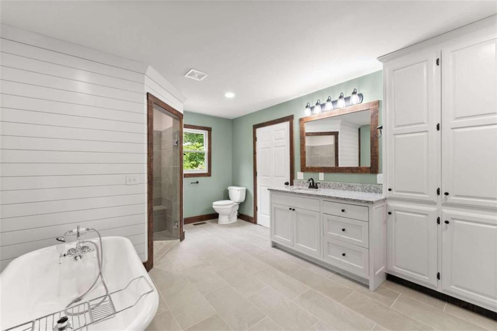 707 South Fern Cove Road Sautee Nacoochee, GA 30571 - Photo 19 of 60 a spacious bathroom with a double vanity sink mirror and bathtub