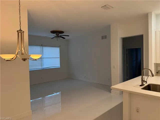 a view of kitchen with stainless steel appliances kitchen island a refrigerator and a sink