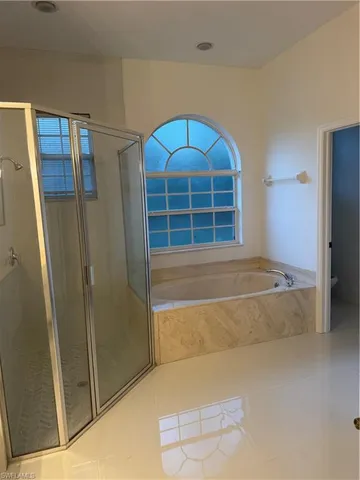 a bathroom with a tub and shower