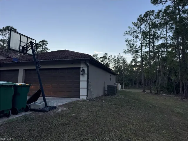 a view of a house with a yard and garage