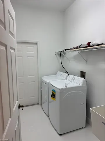 a view of a field with trees in the background