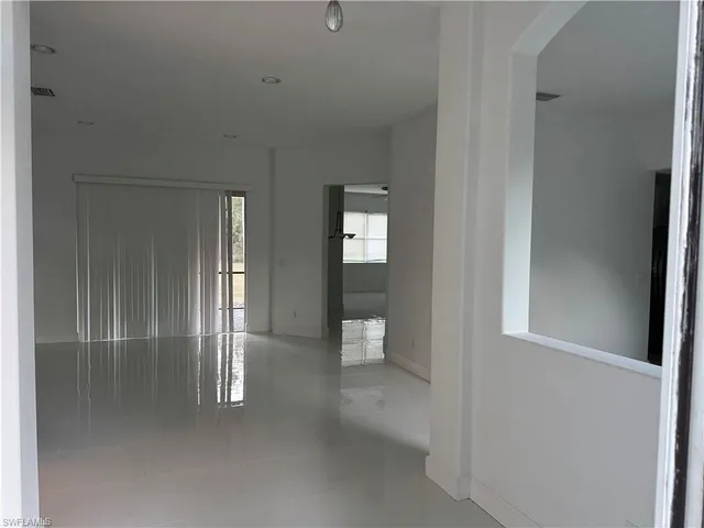 a view of an empty room and bathroom