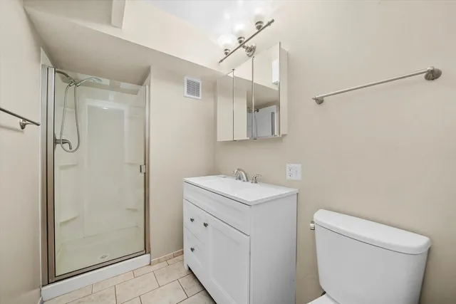 a bathroom with a toilet sink and shower