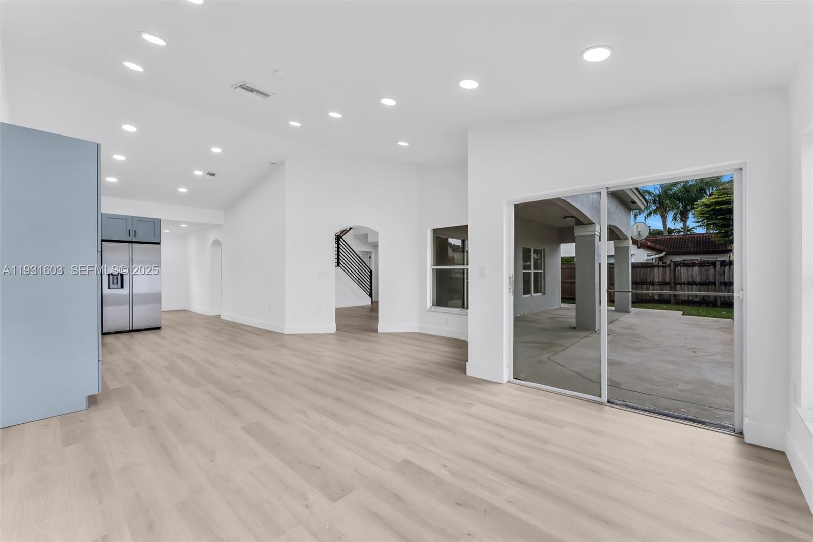 16054 Southwest 77th Terrace Miami, FL 33193 - Photo 15 of 42 a view of empty room with wooden floor and floor to ceiling window
