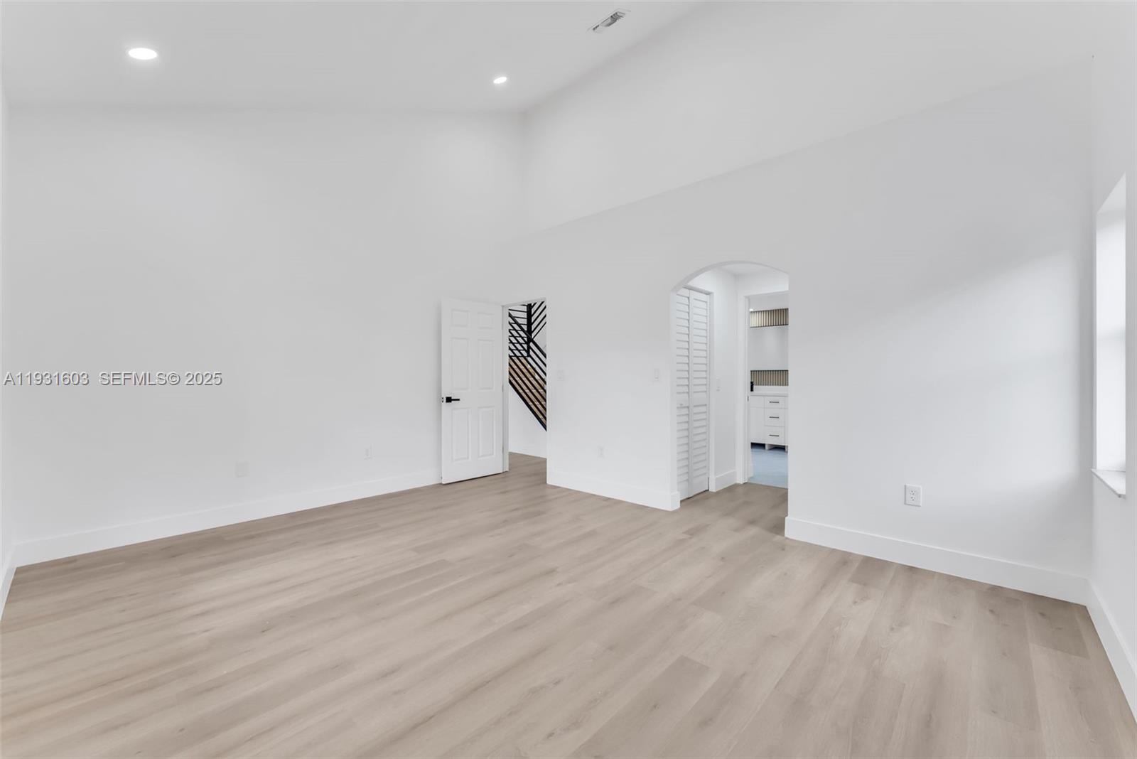 16054 Southwest 77th Terrace Miami, FL 33193 - Photo 19 of 42 an empty room with wooden floor and windows