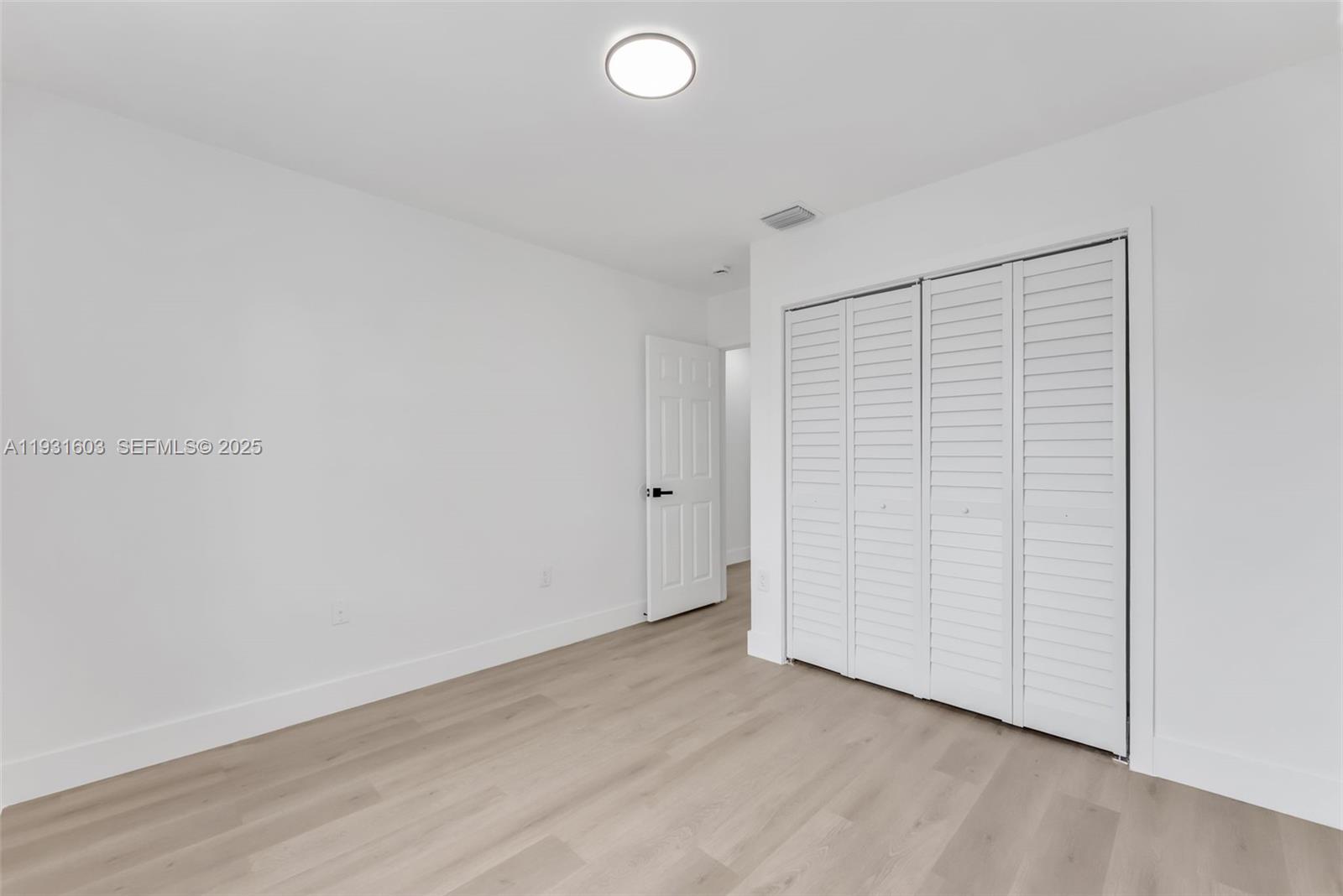 16054 Southwest 77th Terrace Miami, FL 33193 - Photo 27 of 42 an empty room with wooden floor and natural light