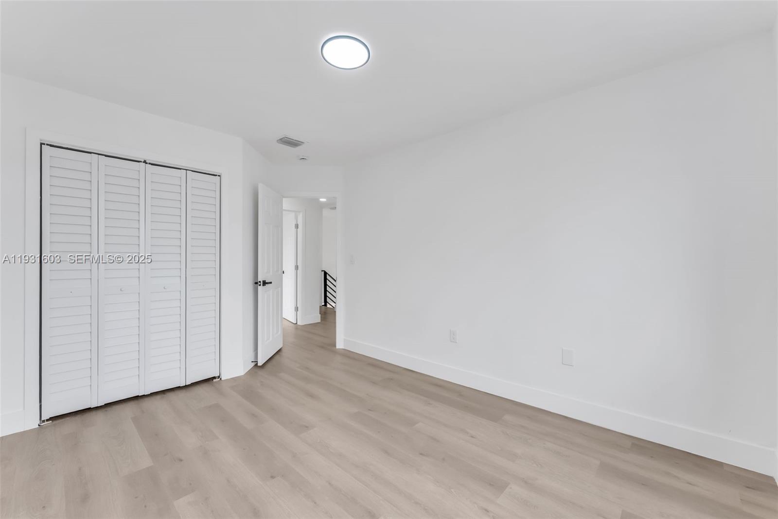 16054 Southwest 77th Terrace Miami, FL 33193 - Photo 30 of 42 a view of an empty room with wooden floor