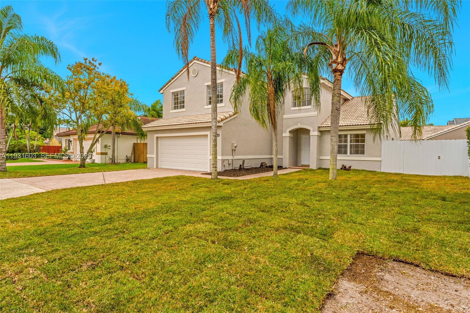 16054 Southwest 77th Terrace Miami, FL 33193 - Photo 3 of 42 a front view of a house with a garden