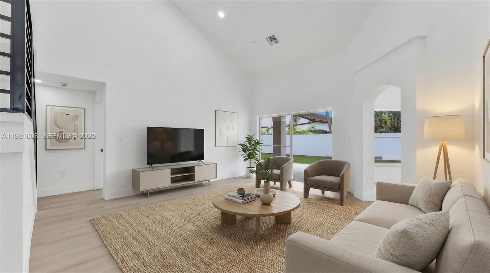16054 Southwest 77th Terrace Miami, FL 33193 - Photo 9 of 42 a living room with furniture and a flat screen tv