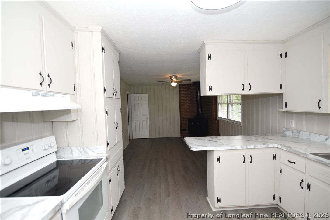 1673 Norment Road Lumberton, NC 28360 - Photo 13 of 32 a kitchen with a sink stove and refrigerator