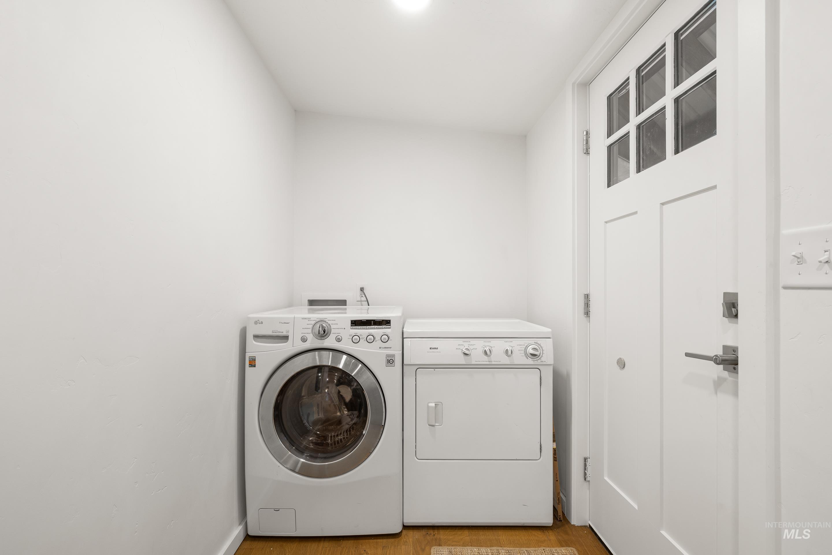 32 Sky Ridge Drive Garden Valley, ID 83622 - Photo 18 of 37 Laundry area with light wood finished floors and washing machine and clothes dryer