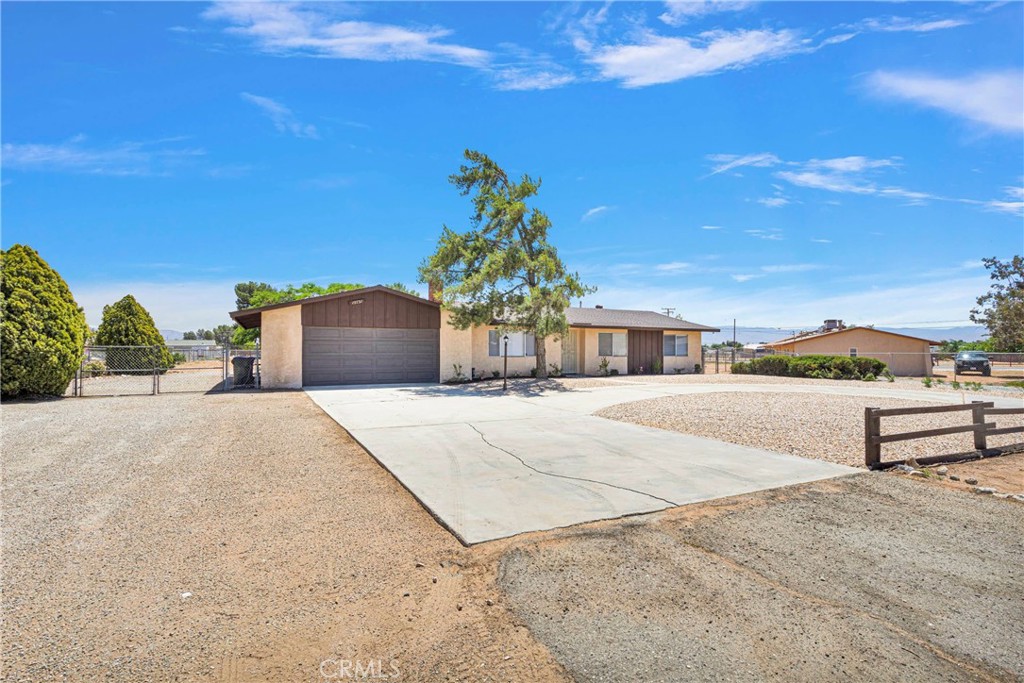 15731 Winnebago Road Apple Valley, CA 92307 - Photo 1 of 1 a front view of a house with a yard