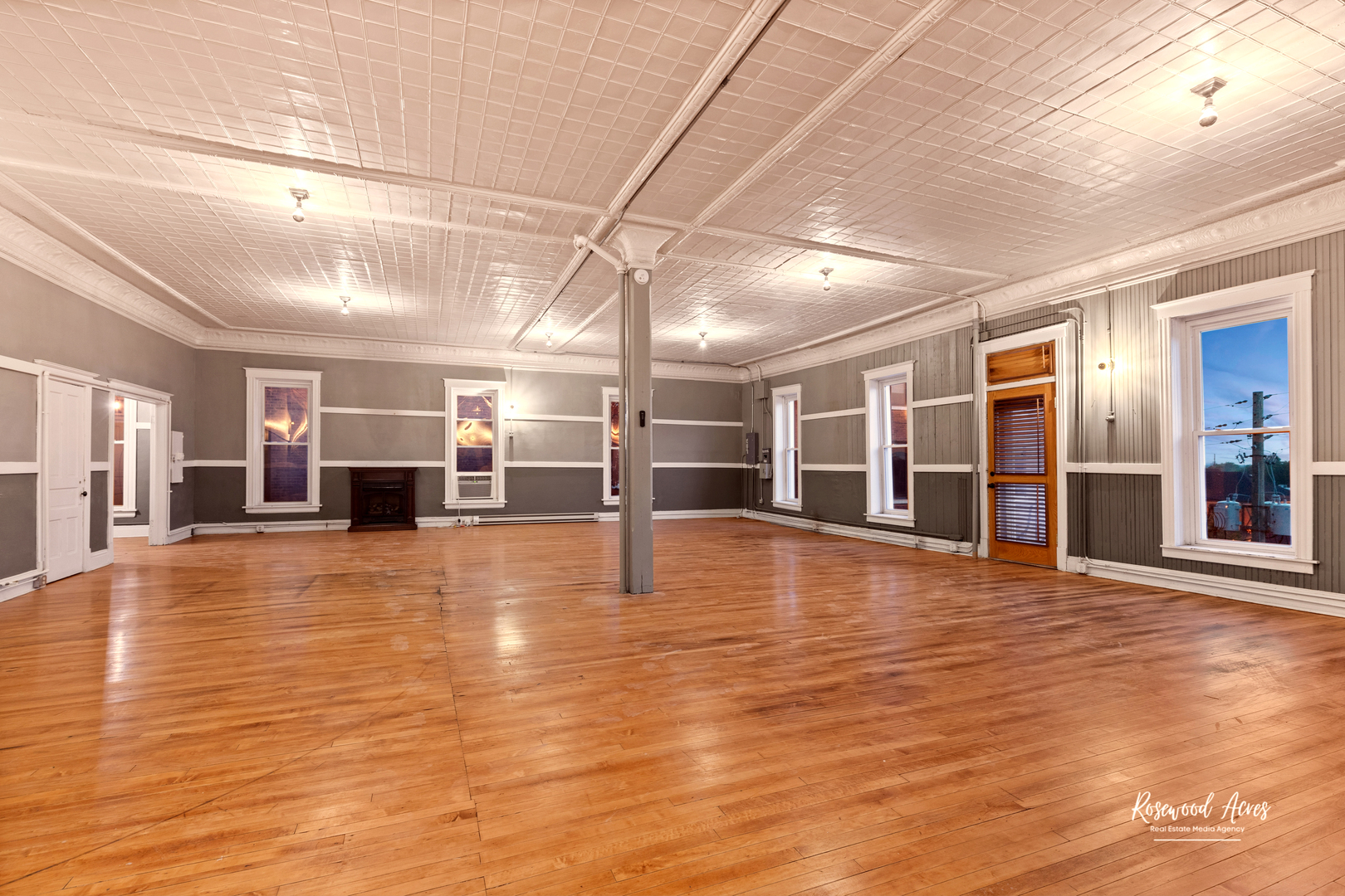 169 South Schuyler Avenue, Unit 6 Kankakee, IL 60901 - Photo 3 of 7 a view of an empty room with wooden floor and windows