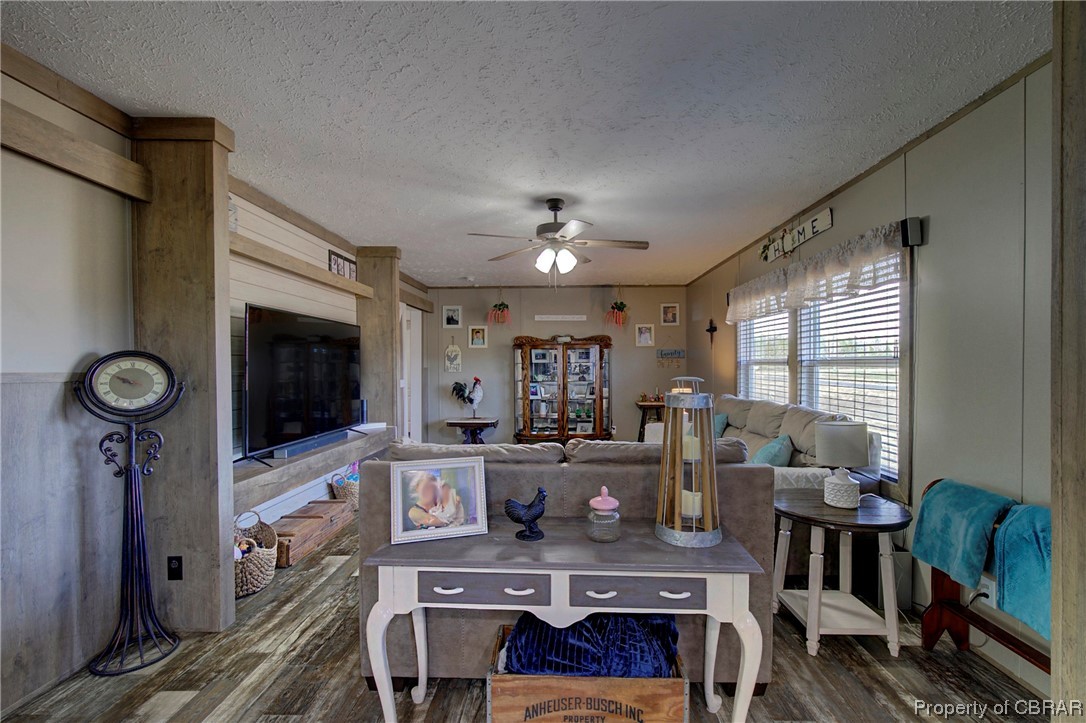 3029 Carsley Road Dendron, VA 23839 - Photo 21 of 26 Living room with dark hardwood / wood-style floors, a textured ceiling, and ceiling fan