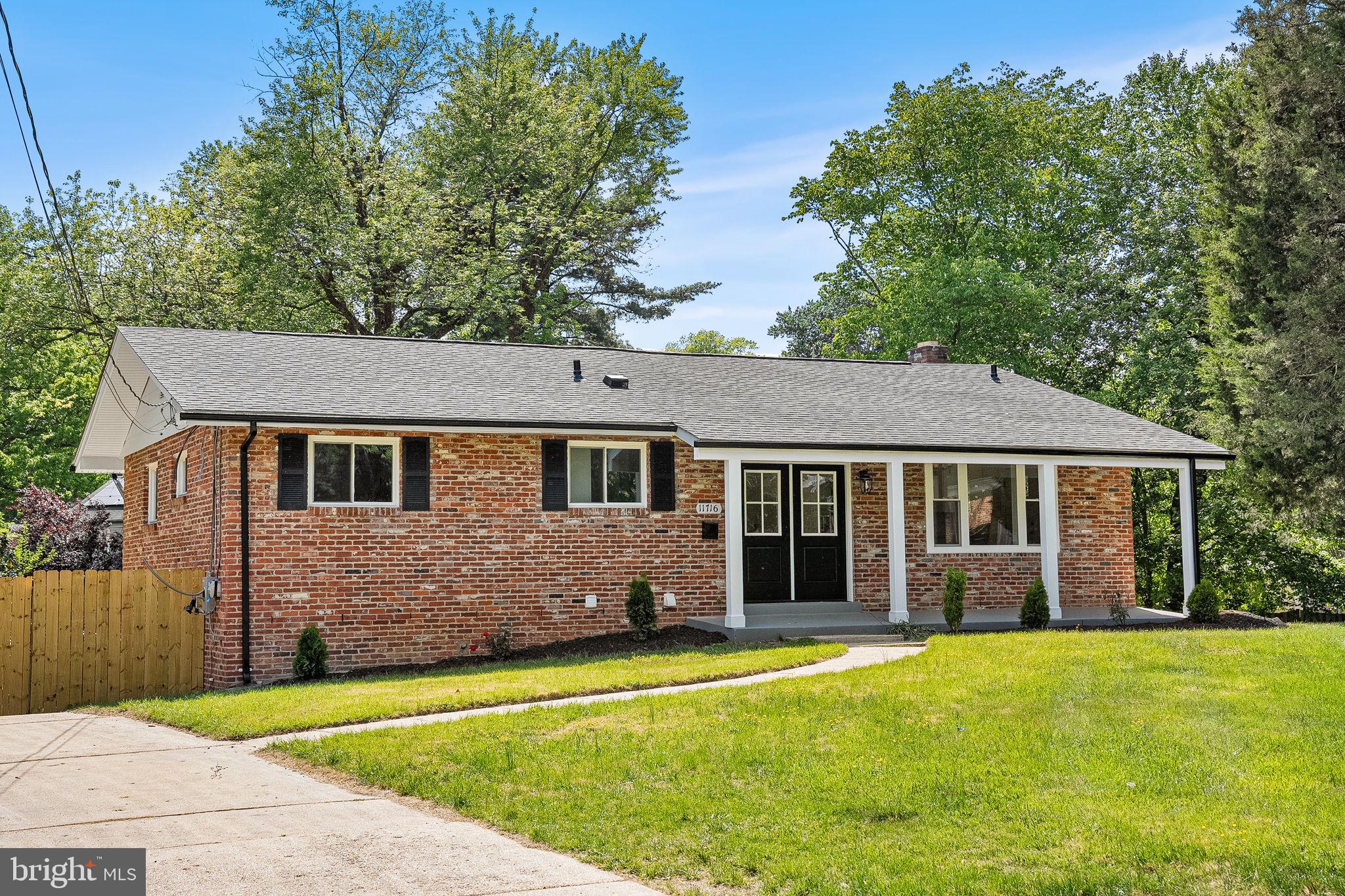 11716 Lovejoy Street Silver Spring, MD 20902 - Photo 1 of 12 a front view of a house with a garden