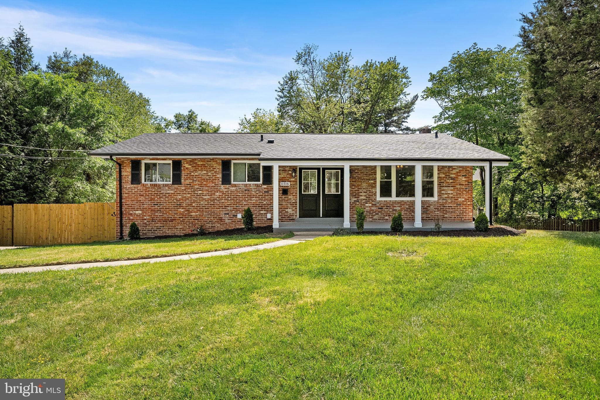 11716 Lovejoy Street Silver Spring, MD 20902 - Photo 2 of 12 front view of a house with a yard