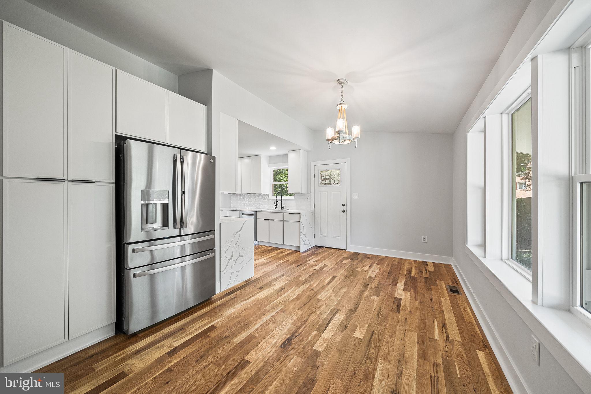 11716 Lovejoy Street Silver Spring, MD 20902 - Photo 4 of 12 a kitchen with kitchen island wooden floor appliances and a window