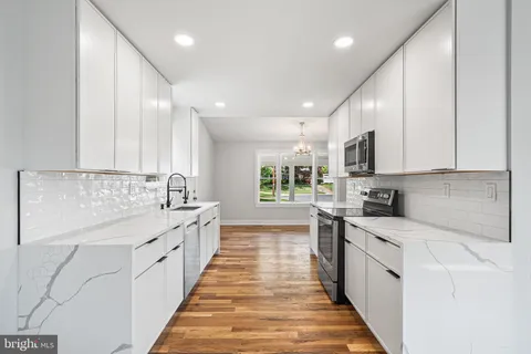 a large kitchen with stainless steel appliances lots of counter space sink and cabinets