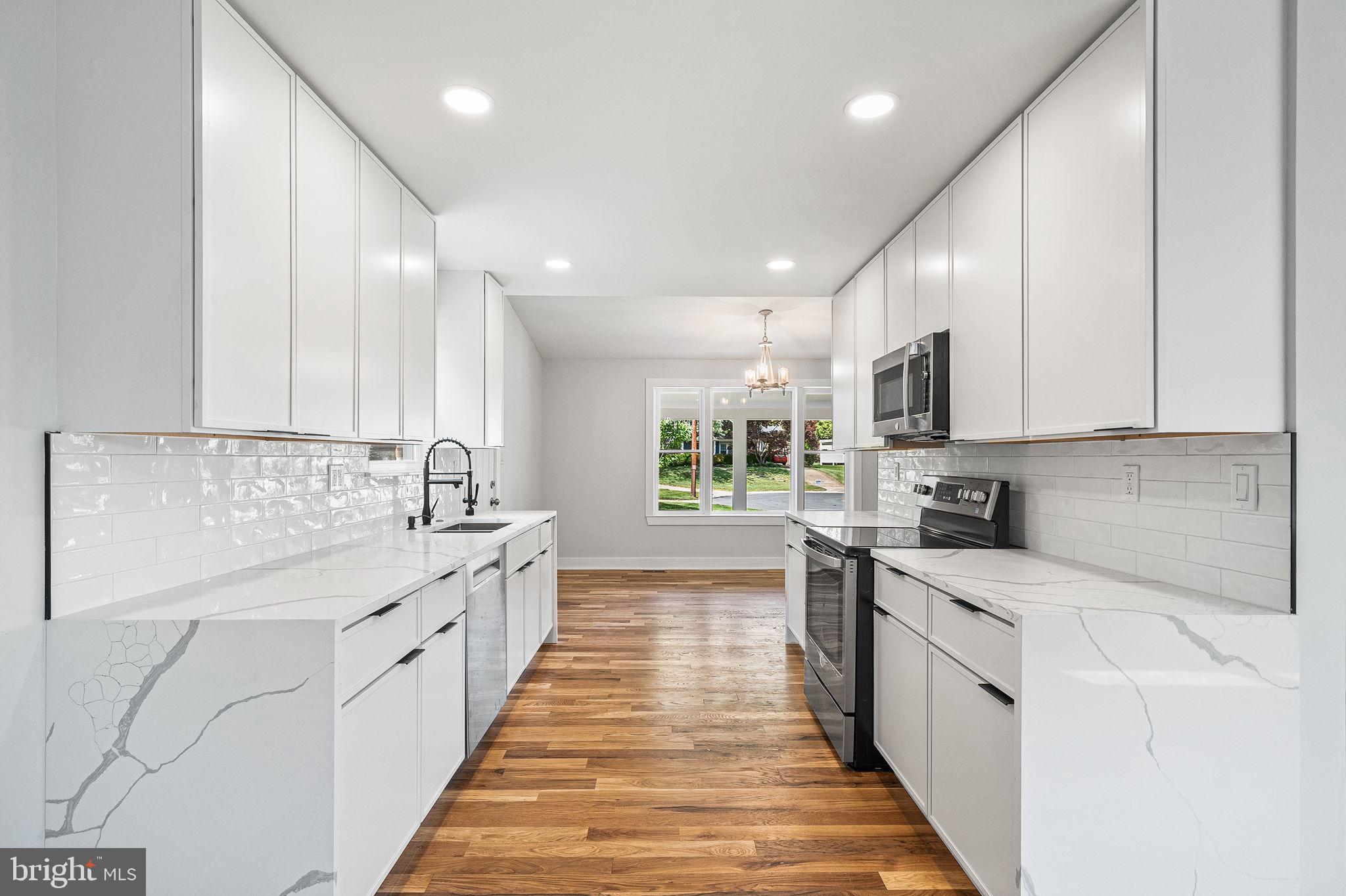 11716 Lovejoy Street Silver Spring, MD 20902 - Photo 5 of 12 a large kitchen with stainless steel appliances lots of counter space sink and cabinets