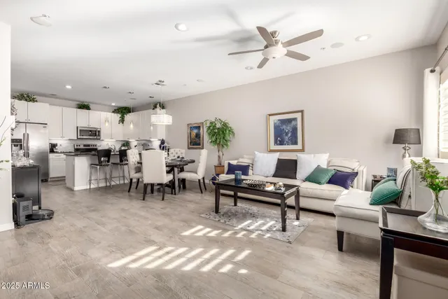 a living room with lots of furniture and kitchen view