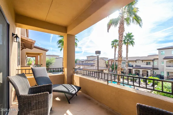 a balcony with furniture and a potted plant