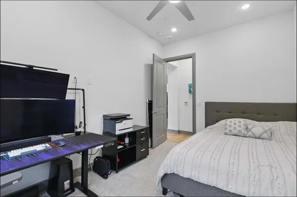 a bedroom with a bed and a desk