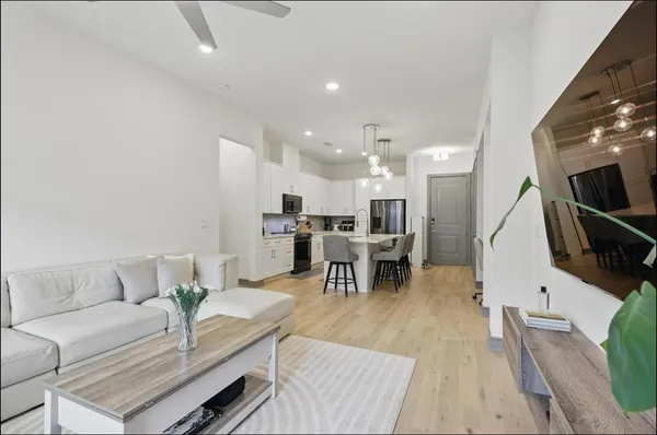 a living room with furniture and kitchen view