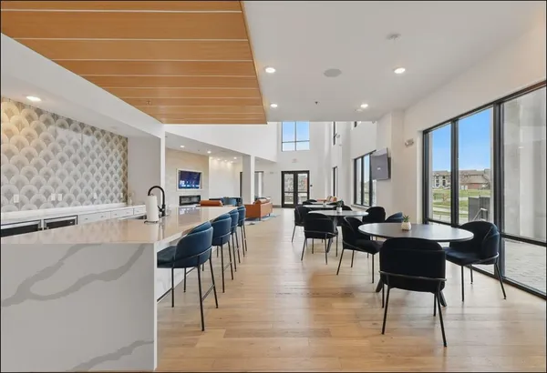 a living room with lots of furniture and a large window