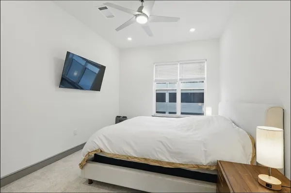a bedroom with a bed and a television