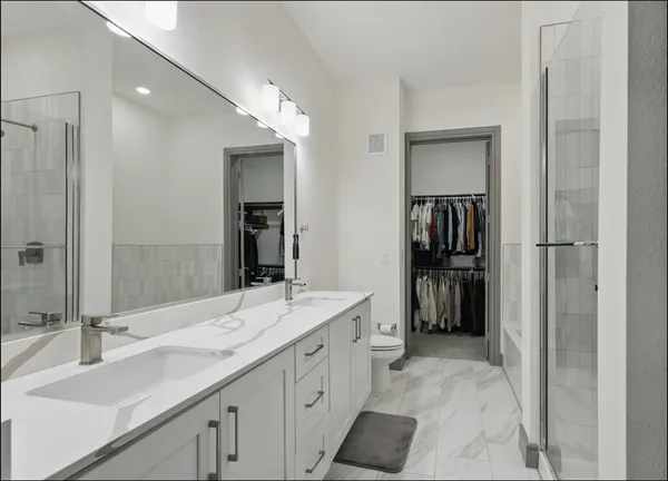a bathroom with a double vanity sink a and mirror