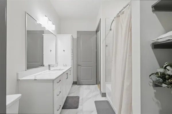 a bathroom with a double vanity sink and mirror