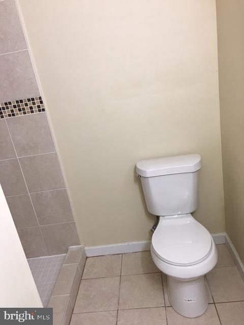 418 Edgewood Street Baltimore, MD 21229 - Photo 6 of 10 a white toilet sitting next to a shower