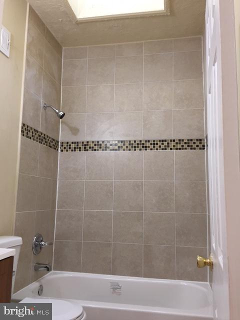 418 Edgewood Street Baltimore, MD 21229 - Photo 8 of 10 a bathroom with a shower and a toilet