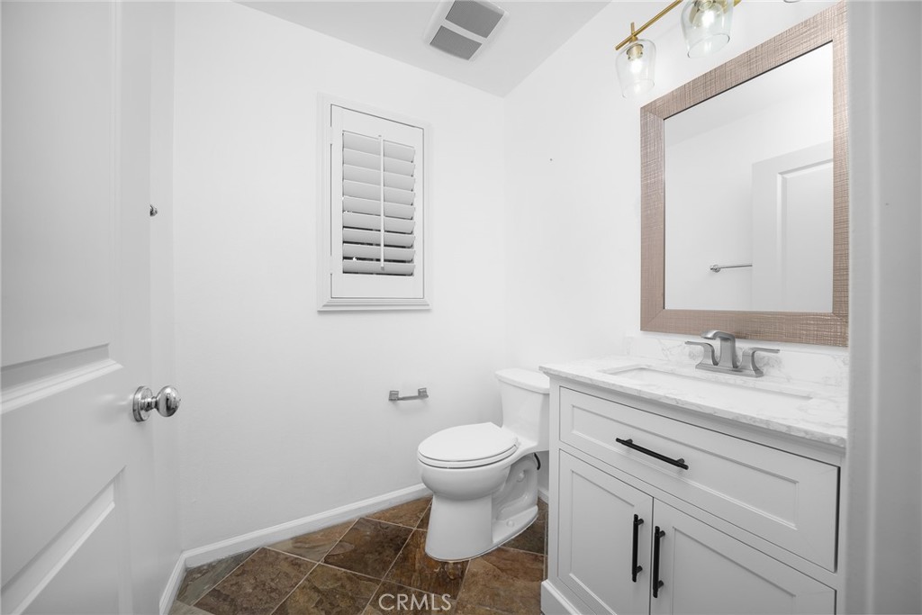 70 Latitude Irvine, CA 92618 - Photo 12 of 27 a bathroom with a granite countertop sink toilet and mirror