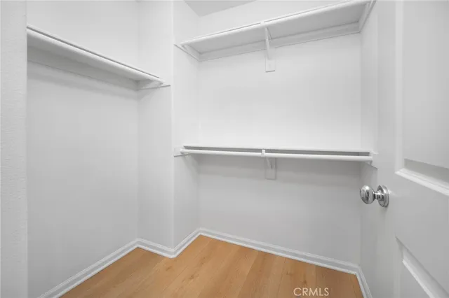 a bathroom with a bathtub shower sink vanity mirror and toilet