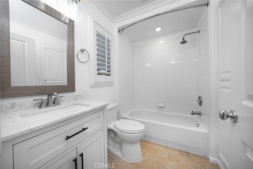 70 Latitude Irvine, CA 92618 - Photo 18 of 27 a bathroom with a bathtub shower sink vanity mirror and toilet