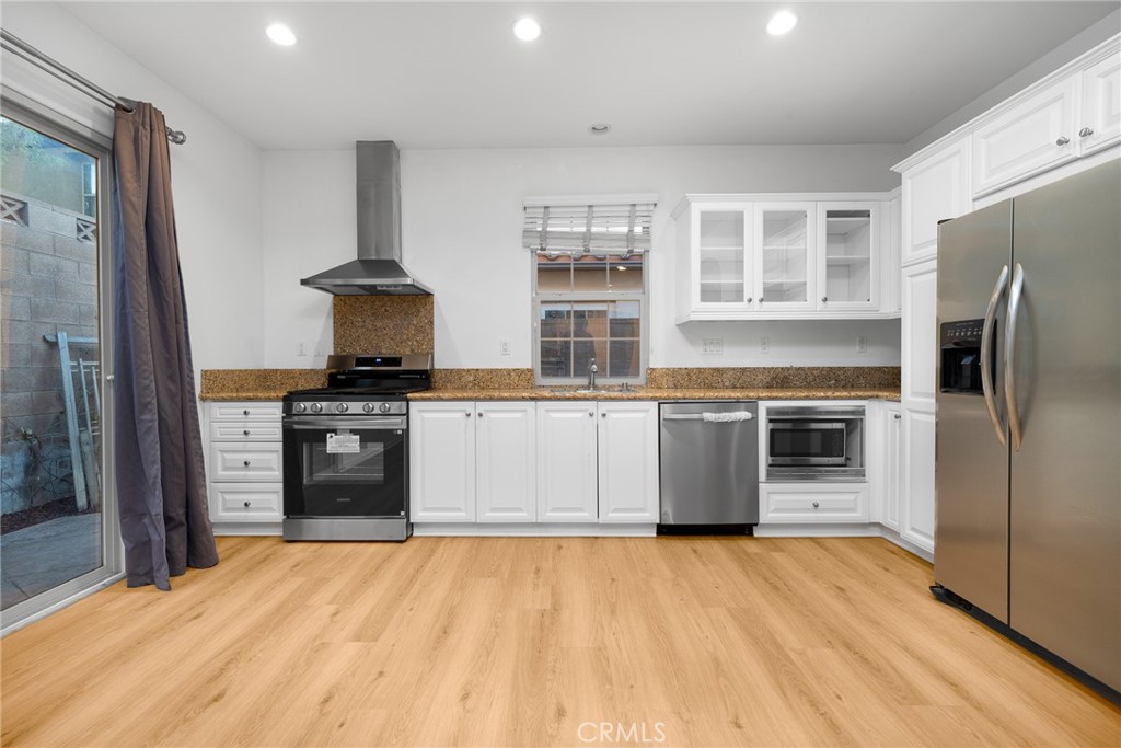 70 Latitude Irvine, CA 92618 - Photo 6 of 27 a kitchen with stainless steel appliances a refrigerator and a stove top oven