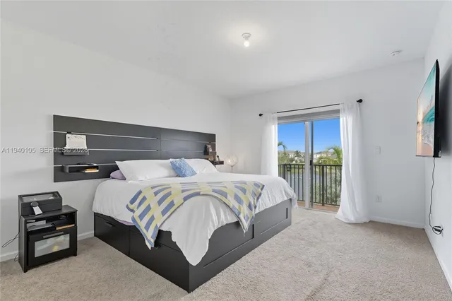 a bedroom with a bed and large window