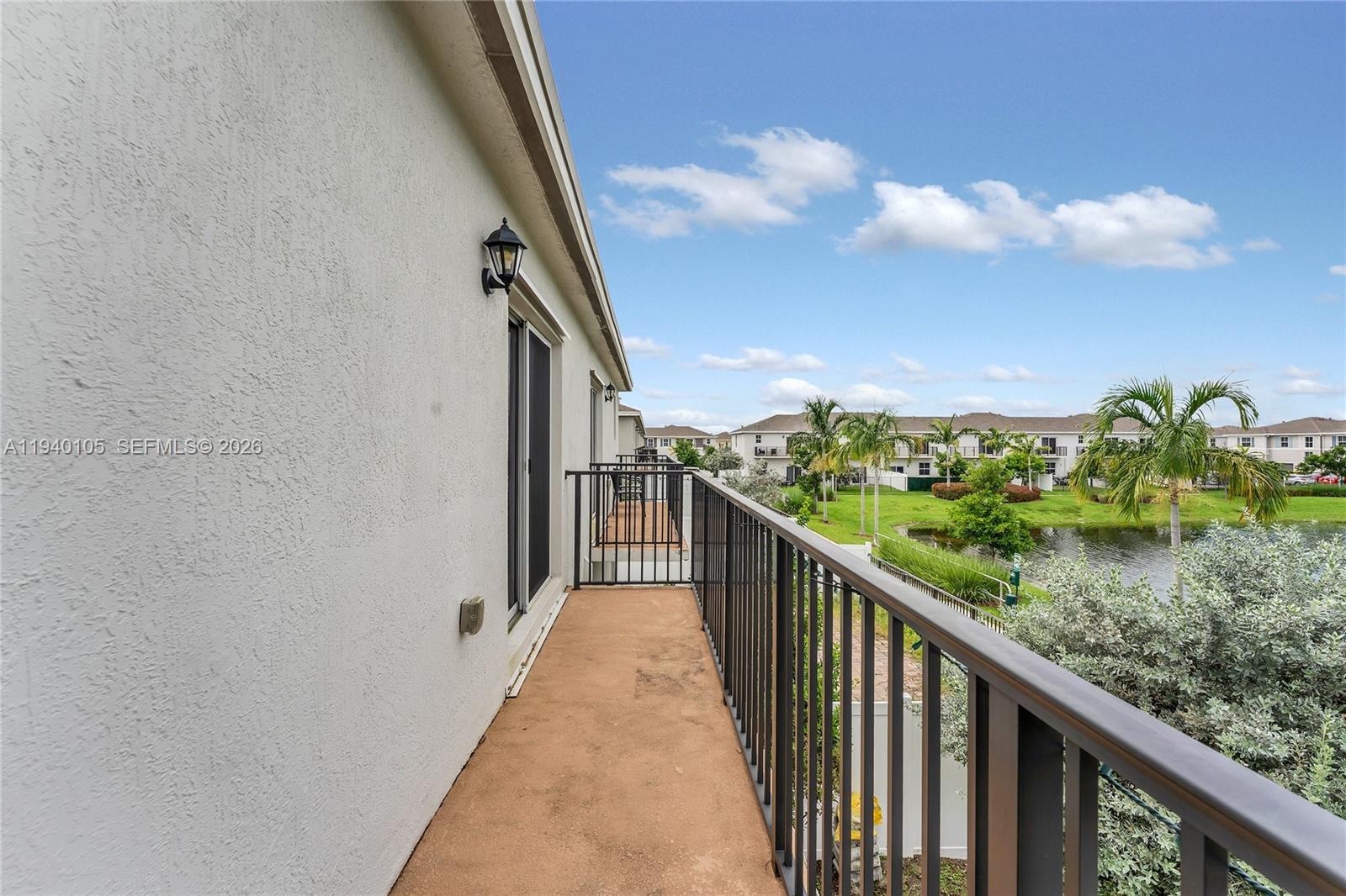 805 South E 18th Street, Unit 805 Homestead, FL 33034 - Photo 16 of 29 a view of a balcony with wooden floor and fence