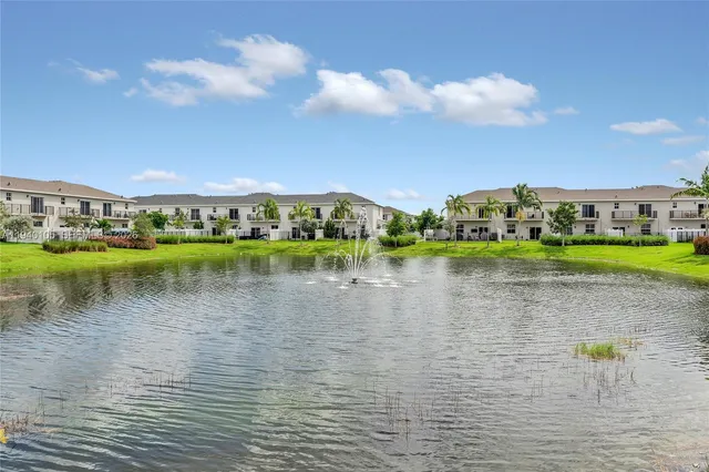 a view of a lake with houses in the back