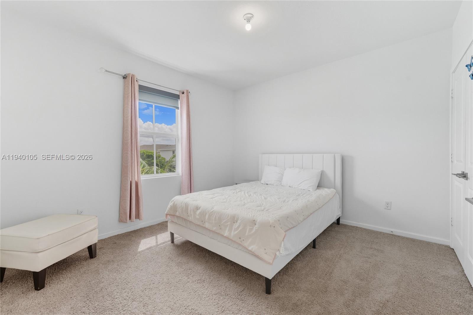 805 South E 18th Street, Unit 805 Homestead, FL 33034 - Photo 20 of 29 a bed sitting in a bedroom next to a window