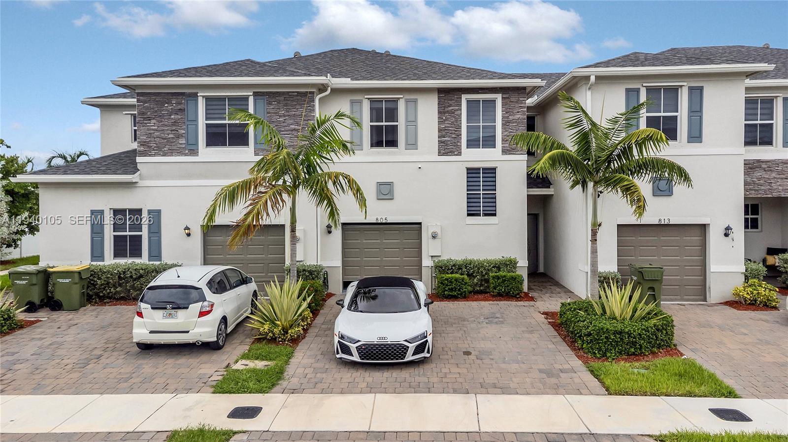 805 South E 18th Street, Unit 805 Homestead, FL 33034 - Photo 2 of 29 a front view of a house with garden