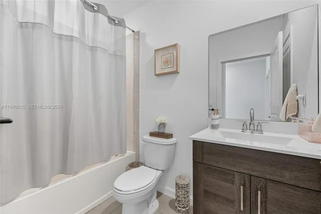 a bathroom with a toilet a sink and a mirror