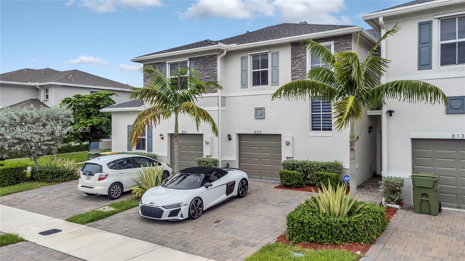 805 South E 18th Street, Unit 805 Homestead, FL 33034 - Photo 3 of 29 a front view of house with yard outdoor seating and barbeque oven